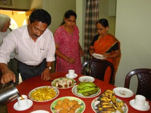 Bijou pouring tea, his wife and mother laying the table
