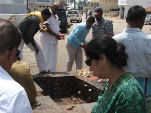 Smashing coconuts as offerings, Chamundi temple